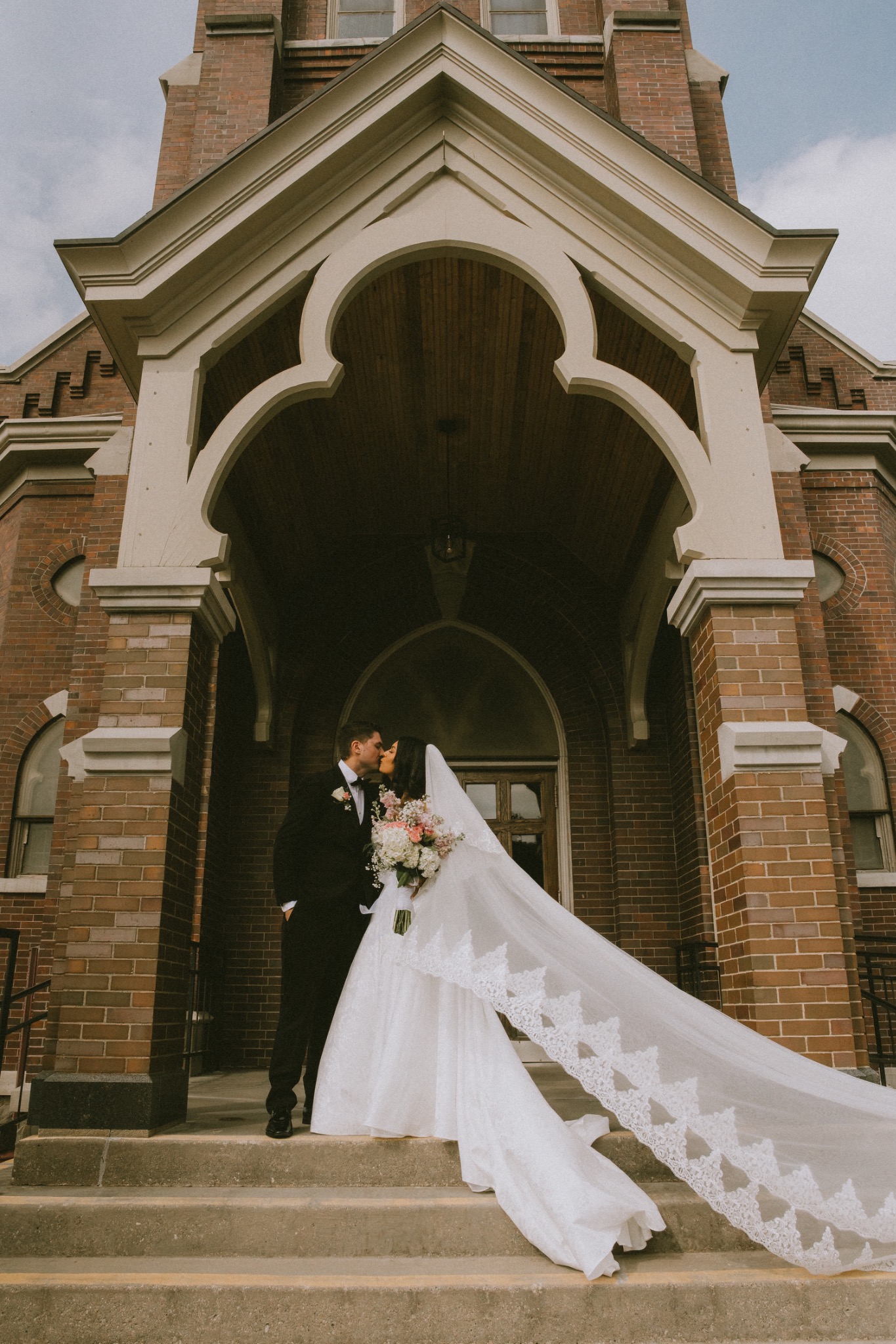 Church wedding portrait with a dramatic cathedral entrance